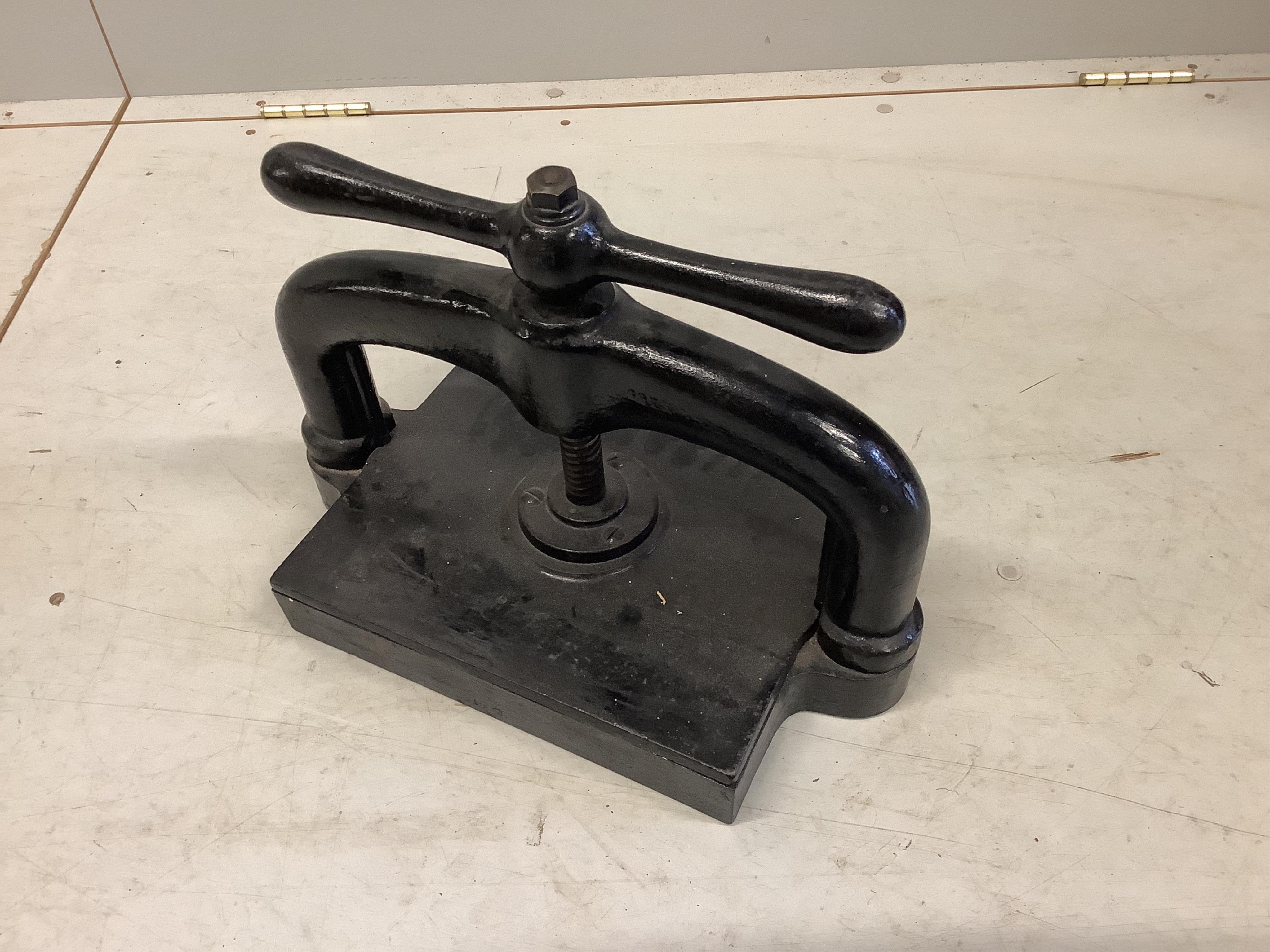 A Victorian cast iron book press, width 42cm, depth 25cm, height 32cm. Condition - fair